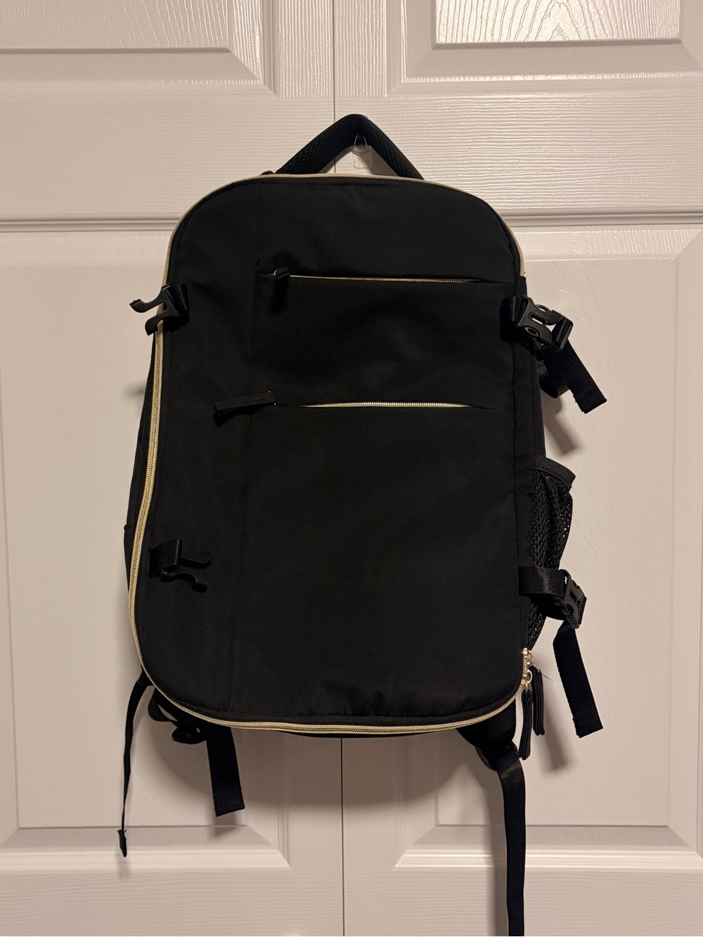 Black Unisex All purpose Backpack with gold hardware
